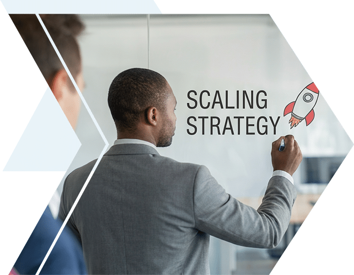 Professional writing 'Scaling Strategy' with a rocket icon on a glass wall